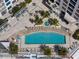 Aerial view of a pool surrounded by lounge chairs, palm trees and lush landscaping at 111 S Pineapple Ave # 716, Sarasota, FL 34236