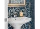 Close up of powder room with wallpaper accent wall, faucet and candle at 111 S Pineapple Ave # 716, Sarasota, FL 34236