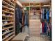 Spacious walk-in closet with custom shelving, drawers, and a cozy bench at 111 S Pineapple Ave # 716, Sarasota, FL 34236