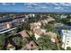 An aerial view showcases the neighborhood, community pool and the surrounding real estate and landscape at 1200 Cove Ii Pl # 832, Sarasota, FL 34242