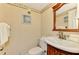 Half bathroom featuring patterned wallpaper, and dark wood vanity at 1200 Cove Ii Pl # 832, Sarasota, FL 34242
