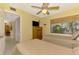 Twin bedroom with a ceiling fan, window, and access to the hallway at 1200 Cove Ii Pl # 832, Sarasota, FL 34242