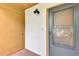 Close up of Unit 832 entrance featuring a screened door, exterior light fixture and door to storage closet at 1200 Cove Ii Pl # 832, Sarasota, FL 34242