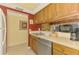 Efficient kitchen layout with dual sinks, wood cabinets, and modern appliances for easy meal preparation at 1200 Cove Ii Pl # 832, Sarasota, FL 34242
