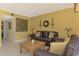Comfortable living room with leather sofas, a wooden coffee table, and decorative wall art for a cozy ambiance at 1200 Cove Ii Pl # 832, Sarasota, FL 34242