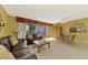 Open-concept living area with a cozy seating area, dining table, cabinet and access to the private balcony at 1200 Cove Ii Pl # 832, Sarasota, FL 34242