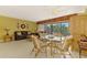 Bright living room featuring tile floors, comfortable seating, dining set and a sliding glass door to the patio at 1200 Cove Ii Pl # 832, Sarasota, FL 34242