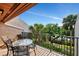 Outdoor patio area furnished with a table and chairs and view of the grounds at 1200 Cove Ii Pl # 832, Sarasota, FL 34242