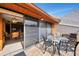 Outdoor patio area with table and chairs, and sliding glass door at 1200 Cove Ii Pl # 832, Sarasota, FL 34242