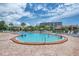 Relaxing community pool area with lounge chairs and lush landscaping, perfect for enjoying sunny days at 1200 Cove Ii Pl # 832, Sarasota, FL 34242