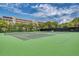Well-maintained tennis courts surrounded by mature trees, offering a great recreational amenity at 1200 Cove Ii Pl # 832, Sarasota, FL 34242