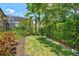Lush backyard featuring vibrant flowers, a well-maintained lawn, and a serene garden path at 12311 Newcastle Pl, Lakewood Ranch, FL 34202
