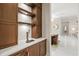 Stylish bar area featuring custom cabinetry, a countertop, and a beer tap for sophisticated entertaining at 12311 Newcastle Pl, Lakewood Ranch, FL 34202