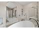 Luxurious bathroom featuring a standalone tub, walk-in shower, and elegant neutral-toned design with modern fixtures at 12311 Newcastle Pl, Lakewood Ranch, FL 34202