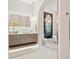 Bright bathroom featuring double vanity, soaking tub, sleek countertops, and elegant floral decor at 12311 Newcastle Pl, Lakewood Ranch, FL 34202