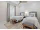 Charming bedroom with two twin beds, complemented by nautical decor and a light-filled window view at 12311 Newcastle Pl, Lakewood Ranch, FL 34202