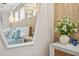 Bedroom with a view of decorative chandelier in a mirror over a dresser and a bedside table at 12311 Newcastle Pl, Lakewood Ranch, FL 34202