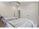 Serene bedroom featuring twin beds, a ceiling fan, and a spacious closet with a bright and airy atmosphere at 12311 Newcastle Pl, Lakewood Ranch, FL 34202