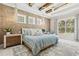 Spacious bedroom with decorative wallpaper, wood beams, chandeliers, and a pool view at 12311 Newcastle Pl, Lakewood Ranch, FL 34202