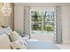 Comfortable bedroom with view to the pool through a large window with decorative curtains at 12311 Newcastle Pl, Lakewood Ranch, FL 34202