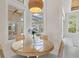 Bright breakfast nook with wicker table, chairs, pendant light, and views of the pool and outdoor area at 12311 Newcastle Pl, Lakewood Ranch, FL 34202