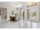 Elegant dining room featuring a modern chandelier, large windows with sheer curtains, and light-colored wood floors at 12311 Newcastle Pl, Lakewood Ranch, FL 34202