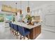 Bright, open kitchen with a large island, bar seating, modern pendant lights, and stainless steel appliances at 12311 Newcastle Pl, Lakewood Ranch, FL 34202