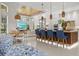 Open-concept kitchen featuring bar seating, a wood ceiling, and views of the backyard and living area at 12311 Newcastle Pl, Lakewood Ranch, FL 34202