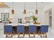 Modern kitchen island with bar seating, pendant lighting, stainless steel appliances, and open floor plan at 12311 Newcastle Pl, Lakewood Ranch, FL 34202