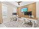 Bright office featuring dual desks, a wall-mounted TV, and ample natural light for a productive workspace at 12311 Newcastle Pl, Lakewood Ranch, FL 34202