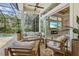Relaxing screened-in patio features contemporary furniture, fireplace, TV, and access to backyard pool at 12311 Newcastle Pl, Lakewood Ranch, FL 34202