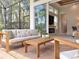 Covered patio area with comfortable seating and view into home's living room through sliding glass doors at 12311 Newcastle Pl, Lakewood Ranch, FL 34202