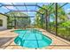 Backyard oasis featuring a screened pool, patio, and lush landscaping for ultimate relaxation and privacy at 12311 Newcastle Pl, Lakewood Ranch, FL 34202