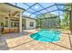 Pool area with enclosed screen, brick patio, jacuzzi and outdoor seating, seamlessly blending indoor and outdoor living at 12311 Newcastle Pl, Lakewood Ranch, FL 34202