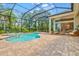 Enclosed pool area with a brick patio, pool, and jacuzzi, offering a relaxing outdoor living space at 12311 Newcastle Pl, Lakewood Ranch, FL 34202