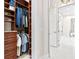 Walk-in closet with custom wood shelving and clothes racks at 12311 Newcastle Pl, Lakewood Ranch, FL 34202