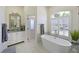Bright bathroom with soaking tub, marble countertops, and modern fixtures at 12811 Penguin Dr, Bradenton, FL 34212