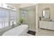 Bathroom featuring soaking tub and glass shower enclosure with designer tile at 12811 Penguin Dr, Bradenton, FL 34212