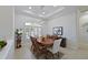 Elegant dining room featuring a wood table, comfortable chairs, and a decorative chandelier at 12811 Penguin Dr, Bradenton, FL 34212