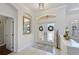 Welcoming entryway with tiled floors, decorative doors and a mirror creating an elegant first impression at 12811 Penguin Dr, Bradenton, FL 34212