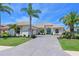 Beautiful one-story home featuring lush landscaping, a side-entry garage and a paver driveway at 12811 Penguin Dr, Bradenton, FL 34212