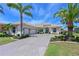 Charming single-Gathering home with a well-manicured lawn, mature palm trees and a spacious driveway at 12811 Penguin Dr, Bradenton, FL 34212