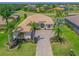 Beautiful single-story home featuring tile roof, lush landscaping and a paver driveway with compass design at 12811 Penguin Dr, Bradenton, FL 34212