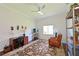 Comfortable living room with a ceiling fan, desk and chair, leather recliner, and area rug at 12811 Penguin Dr, Bradenton, FL 34212