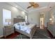 Comfortable bedroom featuring tray ceilings, hardwood floors and bright windows at 12811 Penguin Dr, Bradenton, FL 34212