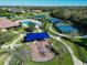 Community playground aerial view with surrounding green space and nearby community amenities at 12811 Penguin Dr, Bradenton, FL 34212