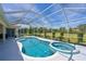 A stunning screened-in pool and spa combination, complemented by manicured landscaping at 12811 Penguin Dr, Bradenton, FL 34212