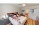 Comfortable bedroom showcasing a wooden bed frame, floral bedding, and a view into the bathroom at 141 Tierra Verde Way, Bradenton, FL 34212