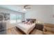 Bedroom with a queen bed, neutral walls, and a window overlooking the yard at 141 Tierra Verde Way, Bradenton, FL 34212