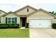 Charming single-story home featuring a well-maintained lawn and a two-car garage at 141 Tierra Verde Way, Bradenton, FL 34212